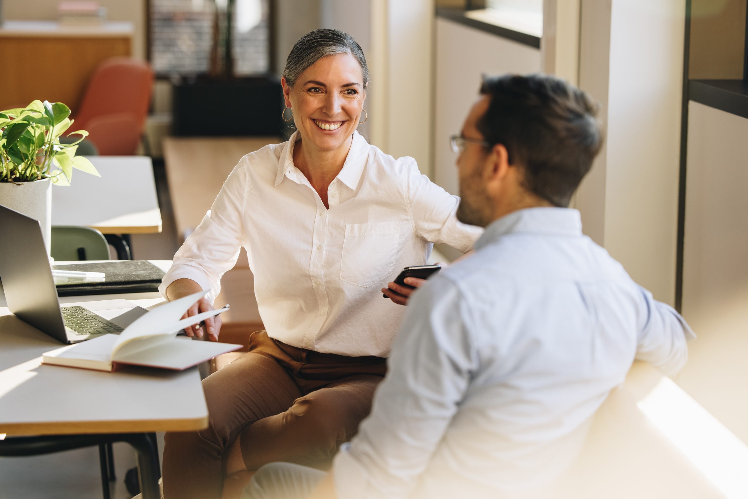 Business,Partners,Sitting,At,Desk,And,Discussing,Business,Strategy.,Entrepreneurs